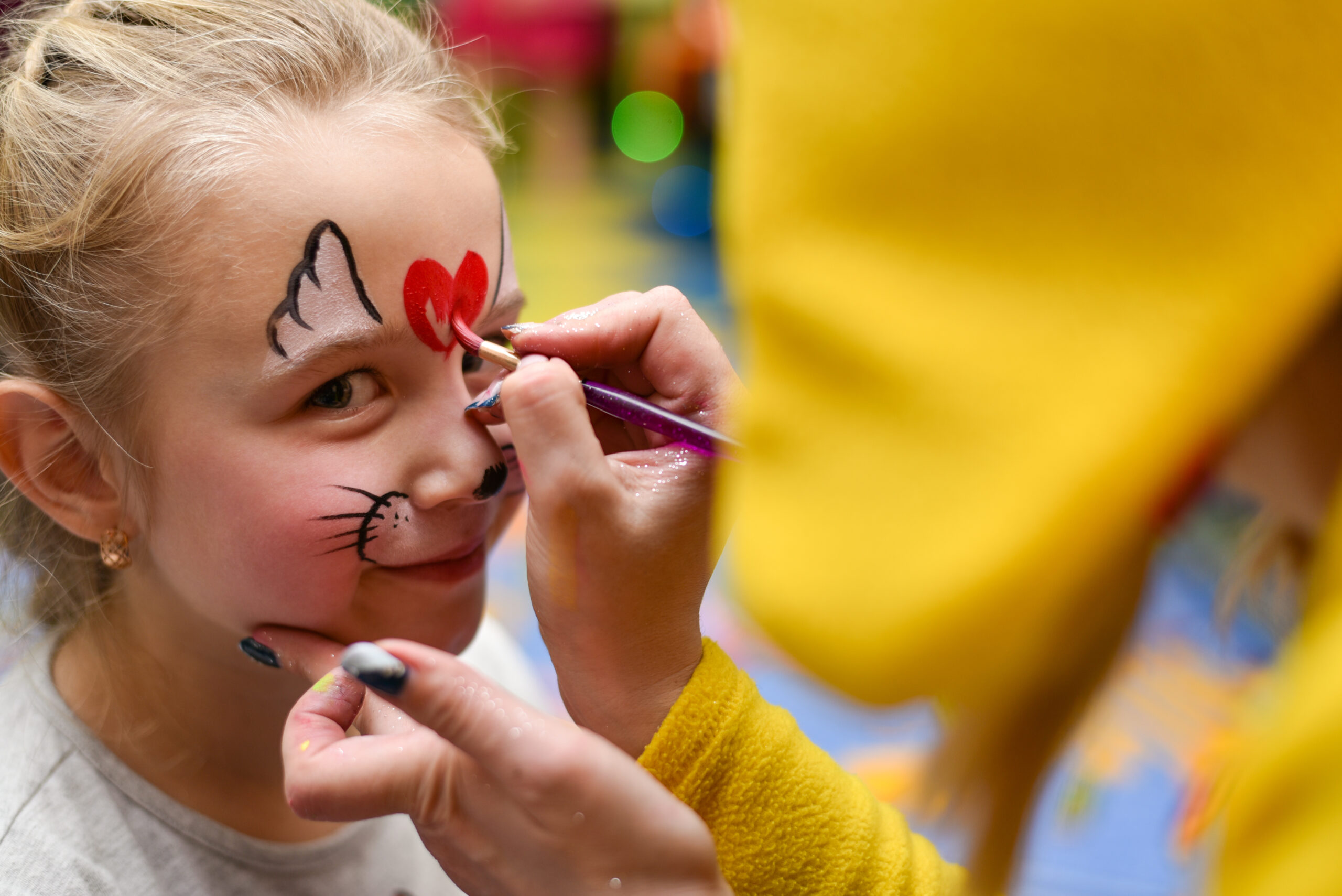 The animator paints the face of the child.